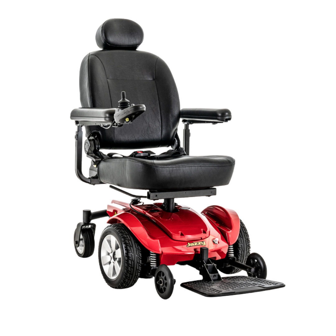 The Pride Mobility Jazzy Select® Powerchair features a modern design with a black cushioned seat, headrest, armrests, red base, right arm joystick controls, and large mid-wheel drive wheels for exceptional mobility.